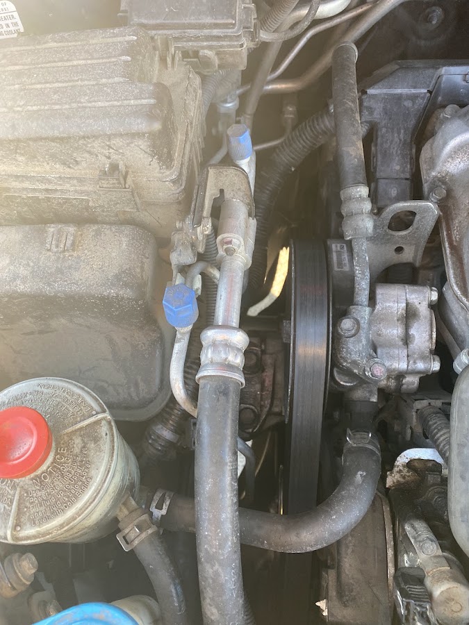 Rescue Me Repair working under the hood on an engine repair